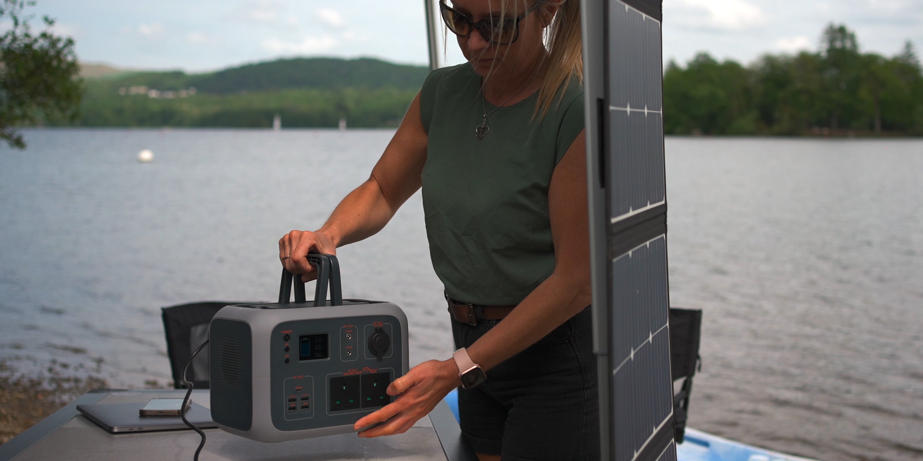 Image of a woman holding a TP500 power generator by the handles outside